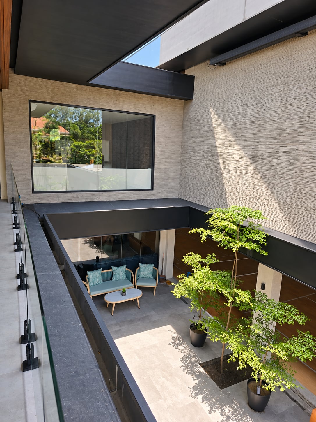 Looking down on the courtyard and its blue lounge chairs
