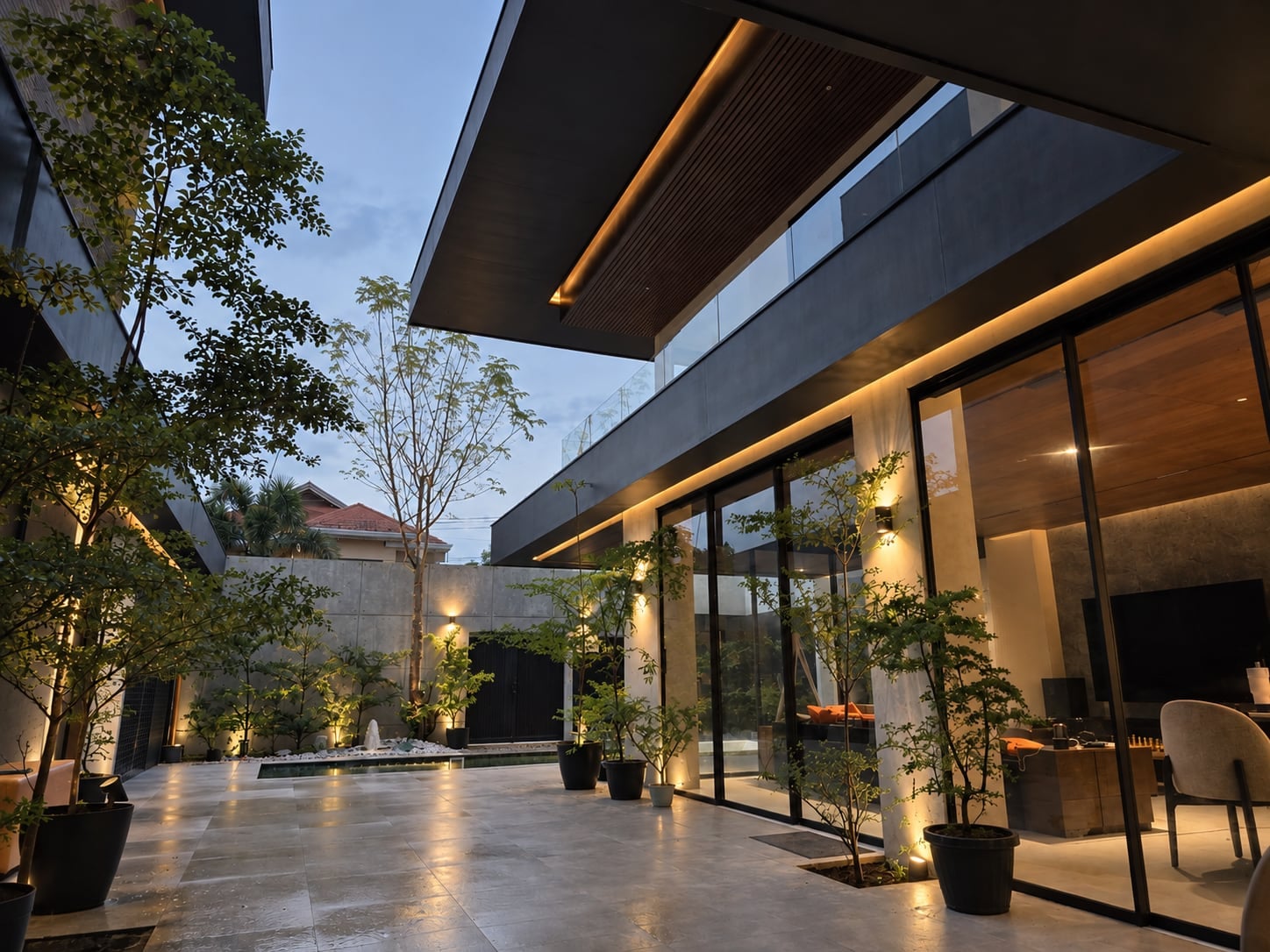 The courtyard and lounge windows lit at dusk